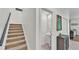 Open hallway near powder room and staircase with carpeted steps and dark wood banister at 6365 Torrington Cir, Lakeland, FL 33811