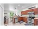 Bright, open kitchen with stainless steel appliances, a spacious counter, and sliding glass doors at 6365 Torrington Cir, Lakeland, FL 33811