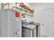 Convenient laundry room with modern washer and dryer, plus ample shelving for storage at 6365 Torrington Cir, Lakeland, FL 33811