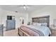 Bright main bedroom featuring a ceiling fan, a comfortable bed and an ample-sized dresser at 6365 Torrington Cir, Lakeland, FL 33811
