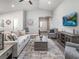 Relaxing living room with a comfortable sofa, stylish decor, and access to other areas of the home at 647 Cypress Creek Run, St Cloud, FL 34771