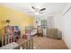 ' bedroom featuring two twin beds, ceiling fan, window, rocking chair, and storage at 6507 Shadowbrook Run, Lakeland, FL 33813