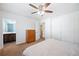 Bedroom features a ceiling fan, neutral carpet, and a door to an ensuite bathroom with vanity at 6507 Shadowbrook Run, Lakeland, FL 33813