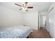 Neutral bedroom featuring a ceiling fan and an adjacent doorway with a closet at 6507 Shadowbrook Run, Lakeland, FL 33813