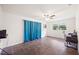 Spacious bedroom with tile flooring, ceiling fan, and bright window at 6507 Shadowbrook Run, Lakeland, FL 33813