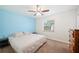 Bedroom features a light blue accent wall, ceiling fan, and carpeted floors at 6507 Shadowbrook Run, Lakeland, FL 33813