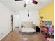 Bedroom with neutral carpet, crib, ceiling fan, and access to an adjacent doorway at 6507 Shadowbrook Run, Lakeland, FL 33813