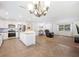 Bright kitchen features stainless appliances, white cabinets, island with butcher block countertop, and adjacent living space at 6507 Shadowbrook Run, Lakeland, FL 33813
