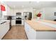 Modern kitchen with white cabinetry, butcher block island, stainless steel appliances, and ample counter space at 6507 Shadowbrook Run, Lakeland, FL 33813