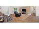 Open-concept living room with a comfortable recliner, large window, and neutral color palette at 6507 Shadowbrook Run, Lakeland, FL 33813