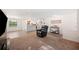 Spacious living area with integrated kitchen view, tile flooring, and modern decor at 6507 Shadowbrook Run, Lakeland, FL 33813