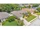 Aerial view of a home with a screened-in pool, manicured lawn, and mature landscaping at 6757 High Grove Dr, Lakeland, FL 33813