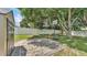 Spacious backyard featuring a basketball hoop and a large shade tree at 6757 High Grove Dr, Lakeland, FL 33813