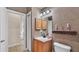 View of the bathroom vanity, medicine cabinet, and toilet at 6757 High Grove Dr, Lakeland, FL 33813