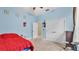 Bright bedroom with carpet flooring, a large closet, and a red bed at 6757 High Grove Dr, Lakeland, FL 33813