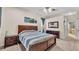 Spacious bedroom with wooden furniture and a view into the bath at 6757 High Grove Dr, Lakeland, FL 33813