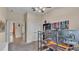 Bright bedroom with a ceiling fan, carpet, and dual computer monitors on a wood desk at 6757 High Grove Dr, Lakeland, FL 33813