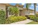 Charming front entrance with lush landscaping, columns, and a welcoming entry door at 6757 High Grove Dr, Lakeland, FL 33813