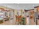 Bright kitchen with tile flooring, an island with bar seating, and stainless steel appliances at 6757 High Grove Dr, Lakeland, FL 33813