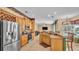 Open kitchen featuring stainless appliances, granite countertops, and convenient bar seating at 6757 High Grove Dr, Lakeland, FL 33813