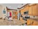 Kitchen boasts granite counters, stainless appliances, and a breakfast bar with seating at 6757 High Grove Dr, Lakeland, FL 33813