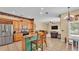 Open kitchen featuring bar seating, modern appliances, and views into living area at 6757 High Grove Dr, Lakeland, FL 33813