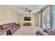 Spacious living room featuring a plush sofa, large TV, and bright natural lighting at 6757 High Grove Dr, Lakeland, FL 33813