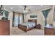 Comfortable bedroom suite with a ceiling fan, large windows, and private access to the outdoor area at 6757 High Grove Dr, Lakeland, FL 33813