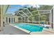Inviting screened-in pool with a spacious deck area for lounging and entertaining guests at 6757 High Grove Dr, Lakeland, FL 33813