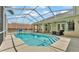 Gorgeous screened-in pool with a covered lanai and lush backyard views at 6757 High Grove Dr, Lakeland, FL 33813