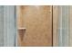 Close up on the neutral tile and glass enclosed shower with built in shelf at 6757 High Grove Dr, Lakeland, FL 33813