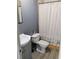 Functional bathroom with a neutral color scheme, essential fixtures, and a shower curtain at 6915 Dove Meadow Trl, Lakeland, FL 33810