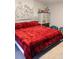 Spacious bedroom with a comfortable bed, a dresser, and a decorative mural at 6915 Dove Meadow Trl, Lakeland, FL 33810