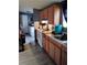 Efficient kitchen layout featuring wood cabinets, modern appliances, and functional design at 6915 Dove Meadow Trl, Lakeland, FL 33810