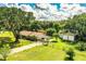Aerial view of a home with a long driveway, a two-car garage, and a fenced-in yard at 6920 Newman E Cir, Lakeland, FL 33811