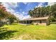 A view of the house and the large yard space from the back of the property at 6920 Newman E Cir, Lakeland, FL 33811