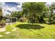 Expansive backyard with lush greenery, patio, and play area, ideal for recreation at 6920 Newman E Cir, Lakeland, FL 33811