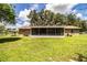 Spacious backyard showcasing the house and screened-in patio for outdoor entertainment at 6920 Newman E Cir, Lakeland, FL 33811