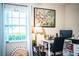 Bedroom featuring natural light, hardwood floors, and a comfortable workspace, creating a functional and inviting atmosphere at 6920 Newman E Cir, Lakeland, FL 33811