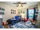 Comfortable bedroom with space decor, plush blue rug and plenty of natural light at 6920 Newman E Cir, Lakeland, FL 33811