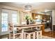 Dining room featuring modern lighting open to the kitchen with breakfast bar at 6920 Newman E Cir, Lakeland, FL 33811