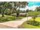 Charming ranch-style home with mature trees, lush landscaping, and a long driveway at 6920 Newman E Cir, Lakeland, FL 33811