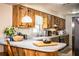 Bright eat-in kitchen featuring stylish wooden cabinets, stainless appliances, and island seating at 6920 Newman E Cir, Lakeland, FL 33811