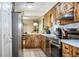 Galley kitchen features stainless steel appliances, wooden cabinets, and bright white countertops at 6920 Newman E Cir, Lakeland, FL 33811