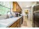 Kitchen with wood cabinets, tile flooring, stainless steel appliances, and large window at 6920 Newman E Cir, Lakeland, FL 33811