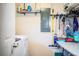 Laundry room featuring modern machines, ample counter space, and storage racks for added convenience at 6920 Newman E Cir, Lakeland, FL 33811