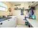 Laundry room featuring modern machines, ample counter space, and storage racks for added convenience at 6920 Newman E Cir, Lakeland, FL 33811