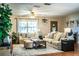 Inviting living room featuring a ceiling fan, comfortable seating, and a large window at 6920 Newman E Cir, Lakeland, FL 33811