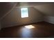 Bright attic featuring a window and wood-look floors at 701 1St Ne St, Fort Meade, FL 33841