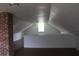 Bright attic featuring a brick column, wood-look floors, and a window at 701 1St Ne St, Fort Meade, FL 33841